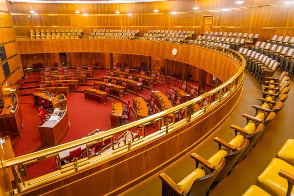 This image shows an empty chamber of a state leglislature.